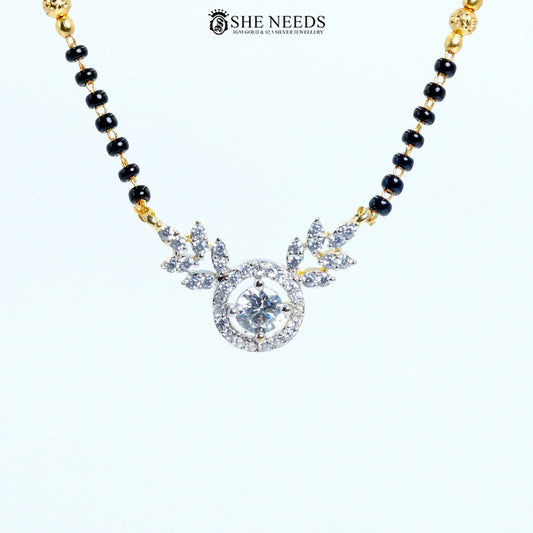 Close-up of Anvika Gold Plated AD Leaf Mangalsutra featuring a round American Diamond pendant with leaf motifs and black bead chain.|She Needs Jewellery