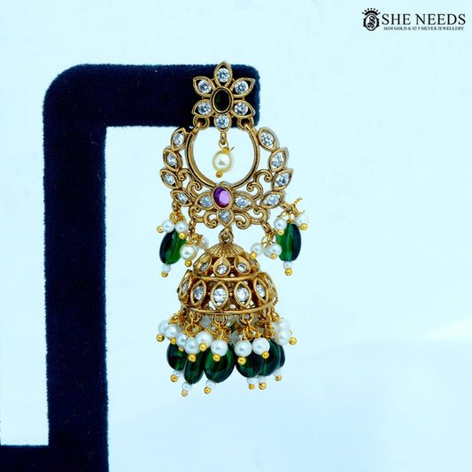 Close-up of Chandrika Antique Gold Crescent Temple Jhumka Earring featuring a floral stud, crescent motif, American Diamonds, ruby-colored stone, pearl accents, and green bead drops.|She Needs Jewellery