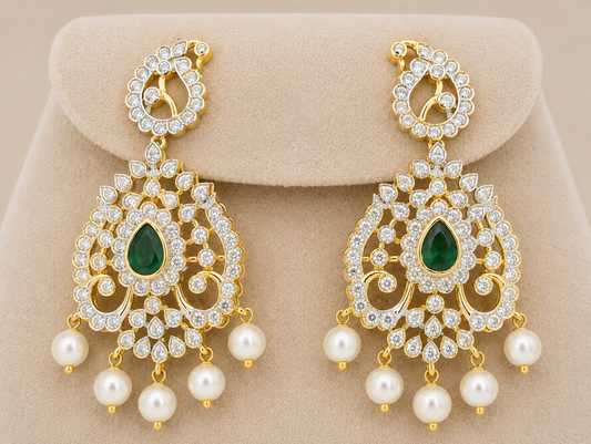 Luxury emerald green American diamond bridal necklace set with pearl drop earrings in gold finish displayed on beige mannequin.