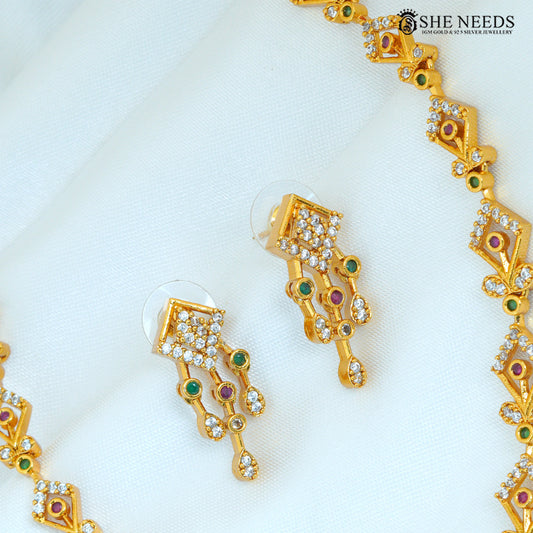 Geometric gold earrings with ruby, green and white stones, featuring a square design and dangling details
|She Needs Jewellery
