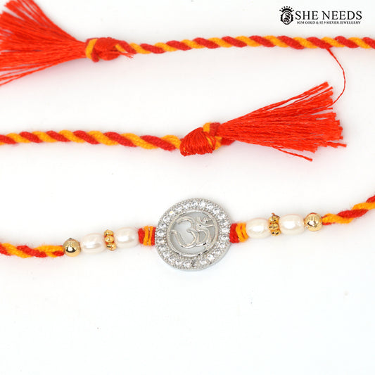 Om Radiance 925 silver Rakhi with pearl beads, sparkling stones and red-yellow braided thread|She Needs Jewellery
