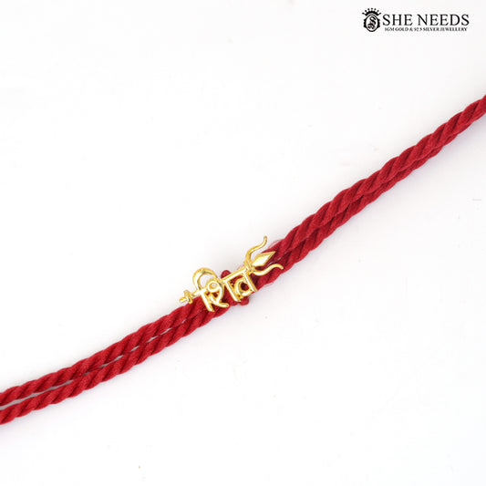 Traditional red thread Shiva Rakhi featuring Hindi “शिव” motif with silver base and gold finish.