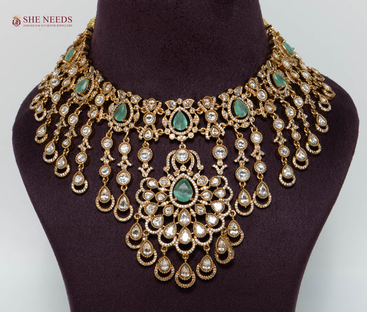 Royal Emerald Green Kundan Bridal Choker Necklace Set with Matching Earrings and Maang Tikka in Antique Gold Finish for Wedding and Bridal Wear