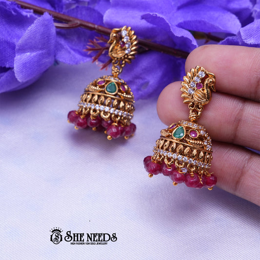 Temple peacock jhumka earrings with CZ stones intricate design and bead danglings for traditional Indian jewellery