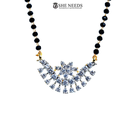 Close-up of Vanya Gold Plated AD Floral Mangalsutra featuring a sparkling floral American Diamond pendant with black bead chain.|She Needs Jewellery
