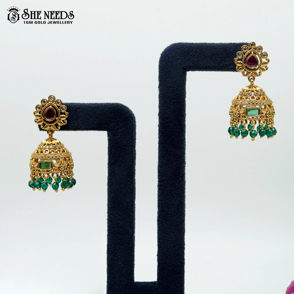 Traditional gold plated South Indian jhumka earrings with green beads and red stone detailing