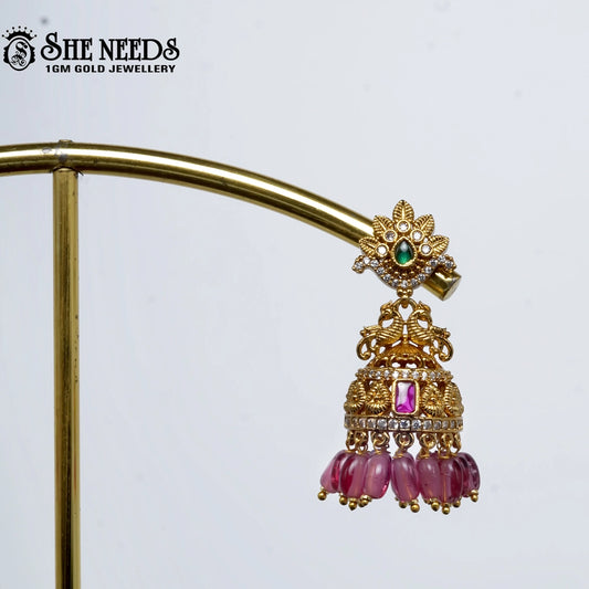 Gold plated green bead jhumkas with pink stone traditional earrings for women