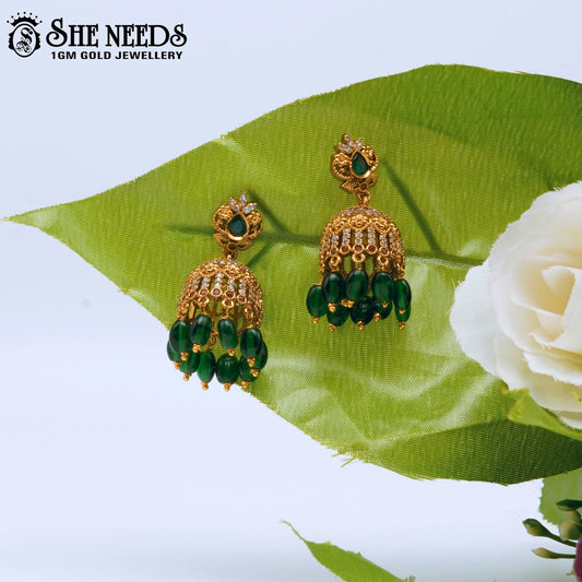 Lakshmi idol temple jhumka earrings with green stone and pearl drops – traditional South Indian jewellery