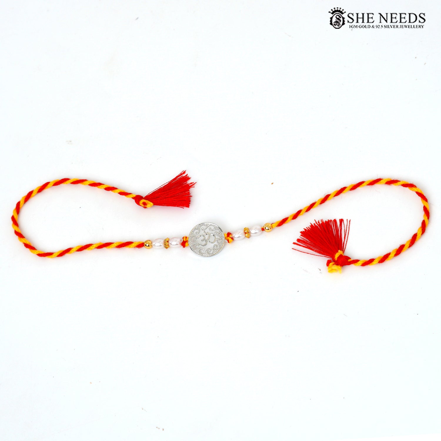 925 silver Om Rakhi with pearl beads, gold-tone accents and red-yellow braided thread|She Needs Jewellery

