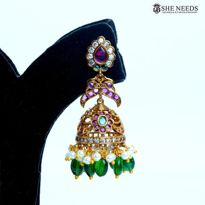Aaradhya floral teardrop jhumka earrings featuring emerald green center stones, ruby pink accents, clear stones and pearl drops|She Needs Jewellery
