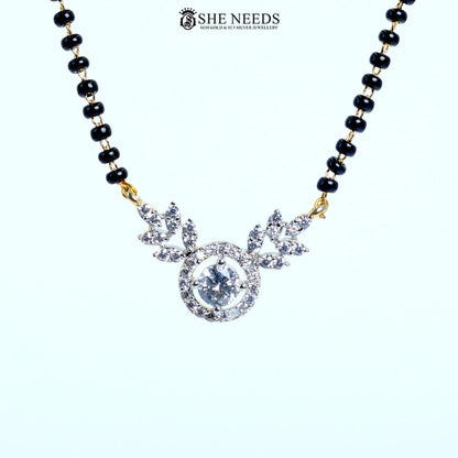 Close-up of Aarini Gold Plated Halo American Diamond Mangalsutra featuring a sparkling round halo pendant with floral marquise-cut CZ stones and a black bead chain. | She Needs Jewellery