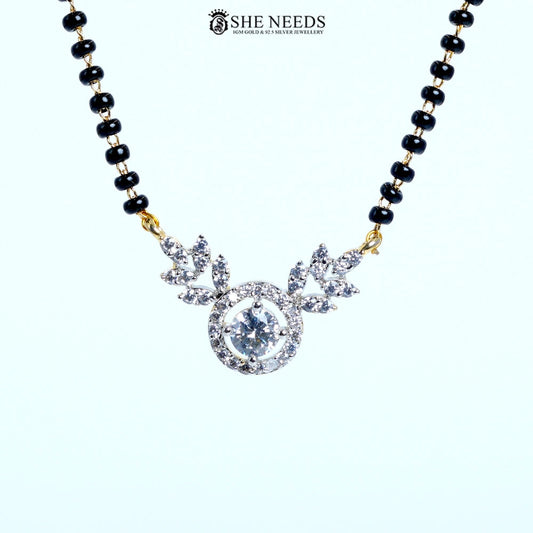 Close-up of Aarini Gold Plated Halo American Diamond Mangalsutra featuring a sparkling round halo pendant with floral marquise-cut CZ stones and a black bead chain. | She Needs Jewellery