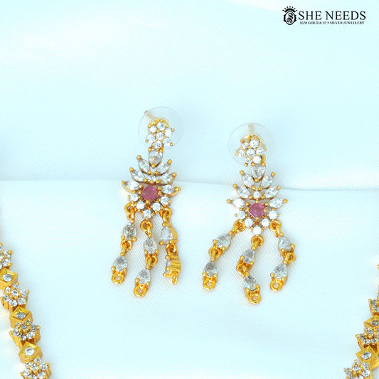 Aarvika ruby geometric gold drop earrings featuring sparkling white stones and cascading pendant details|She Needs Jewellery
