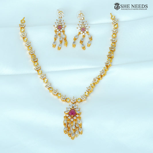 Aarvika ruby geometric gold drop earrings featuring sparkling white stones and cascading pendant details|She Needs Jewellery
