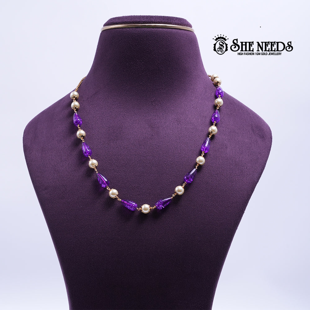 Amethyst Pearl Harmony Necklace featuring faceted amethyst-colored crystal beads, pearl accents, and elegant gold-tone detailing.|She Needs Jewellery
