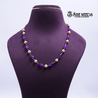 Amethyst Pearl Harmony Necklace featuring faceted amethyst-colored crystal beads, pearl accents, and elegant gold-tone detailing.|She Needs Jewellery
