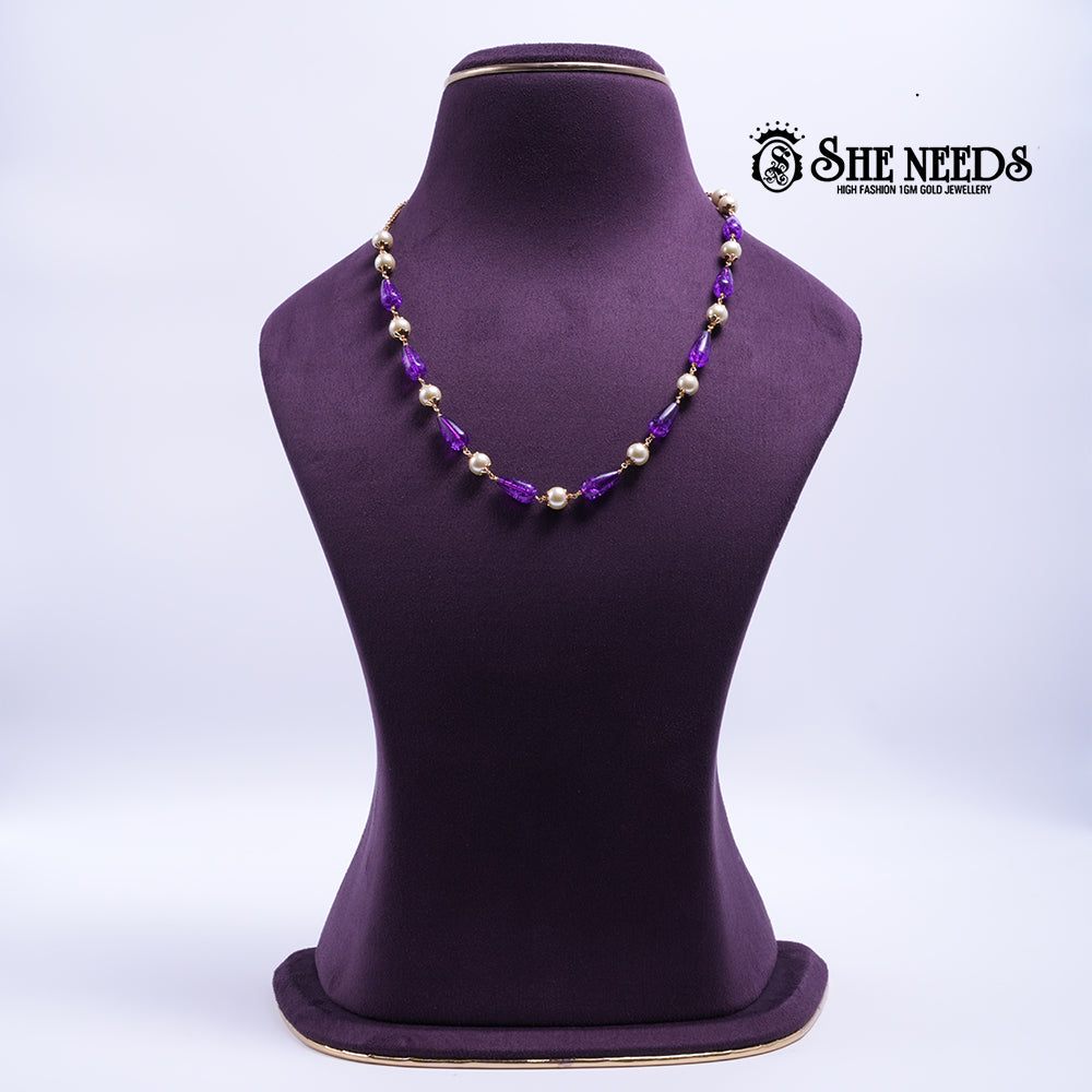 Amethyst Pearl Harmony Necklace featuring faceted amethyst-colored crystal beads, pearl accents, and elegant gold-tone detailing.|She Needs Jewellery
