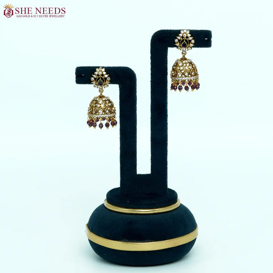 Antique gold-plated jhumka earrings with white zircon stones and purple bead drops for women.|She Needs Jewellery