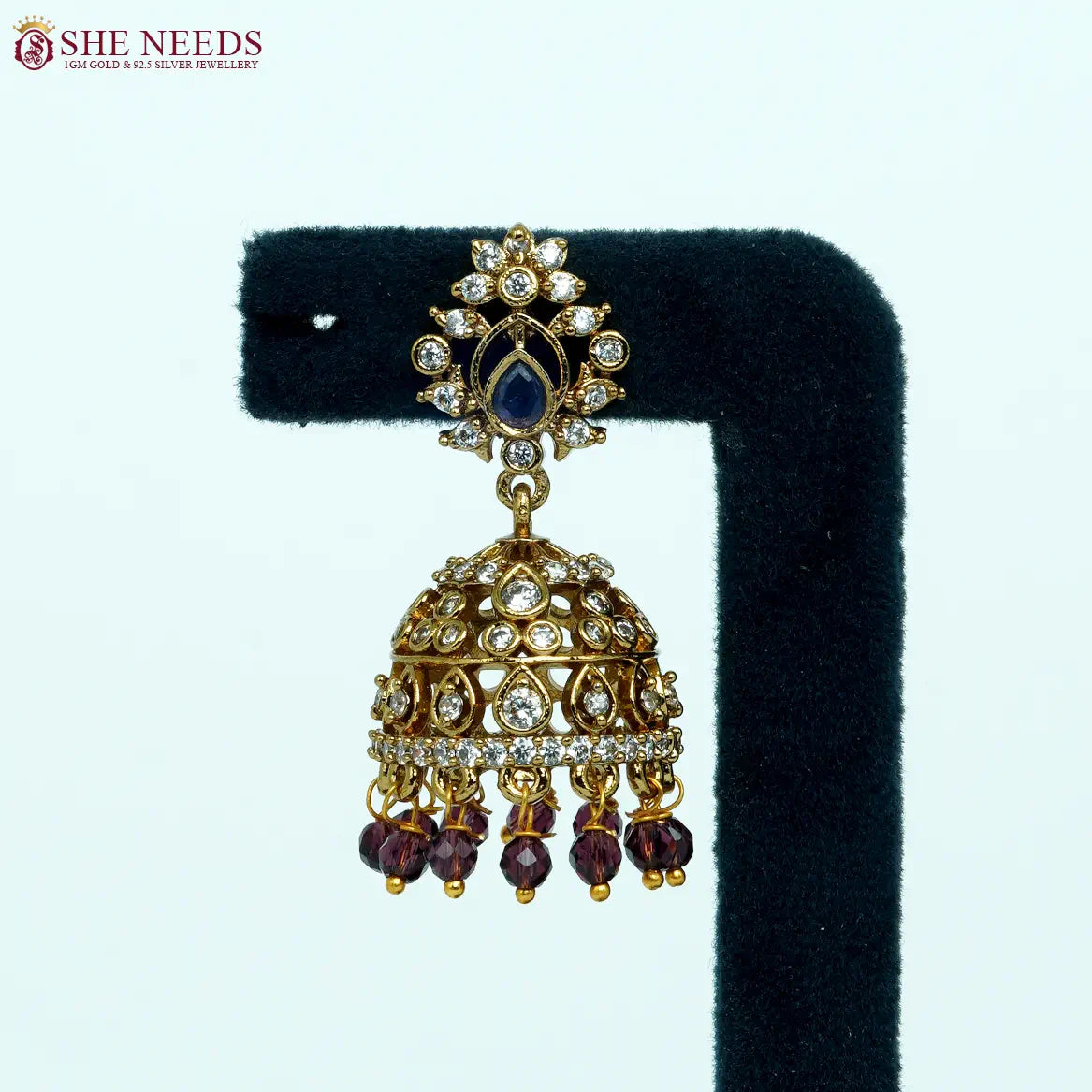 Antique gold-plated jhumka earrings with white zircon stones and purple bead drops for women.|She Needs Jewellery
|She Needs Jewellery