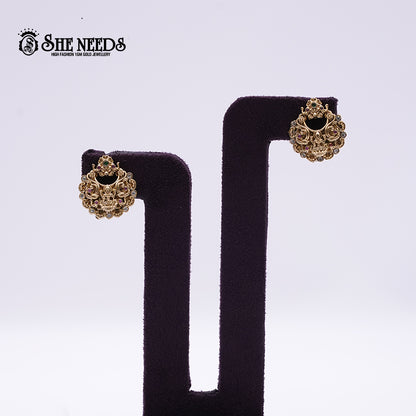Antique Lakshmi Temple Stud Earrings featuring a traditional Lakshmi motif, intricate temple-inspired detailing, sparkling stone accents, and an antique gold finish.|She Needs Jewellery
