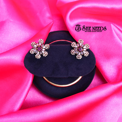Antique Pink Daisy CZ Stud Earrings featuring a floral design with sparkling cubic zirconia stones and a pink center stone.|She Needs Jewellery
