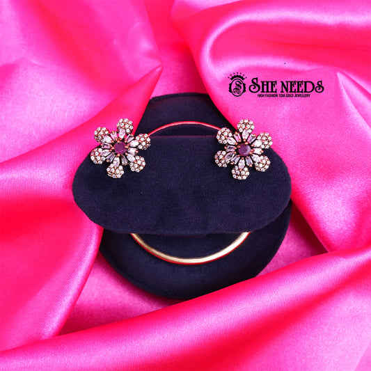 Antique Pink Daisy CZ Stud Earrings featuring a floral design with sparkling cubic zirconia stones and a pink center stone.|She Needs Jewellery
