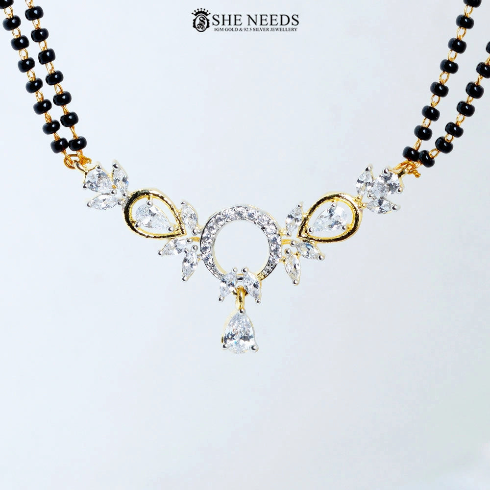 Close-up of Anvika Gold Plated AD Halo Mangalsutra featuring a sparkling halo-style American Diamond pendant with pear-cut CZ stones, floral accents, and black bead chain.|She Needs Jewellery
