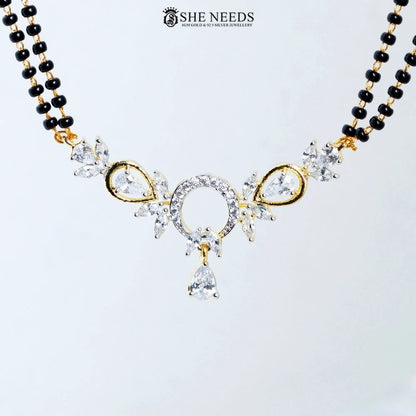 Close-up of Anvika Gold Plated AD Halo Mangalsutra featuring a sparkling halo-style American Diamond pendant with pear-cut CZ stones, floral accents, and black bead chain.|She Needs Jewellery
