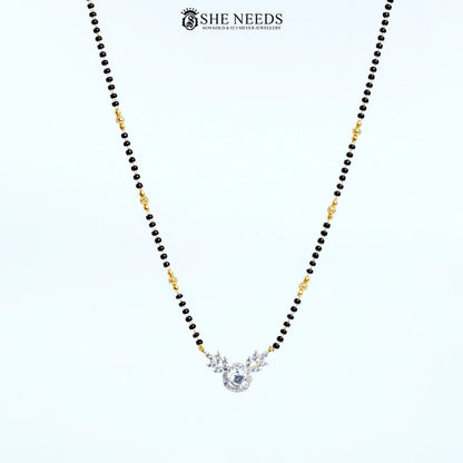 Full view of Anvika Gold Plated AD Leaf Mangalsutra with sparkling round American Diamond pendant, leaf design and black bead chain.|She Needs Jewellery
