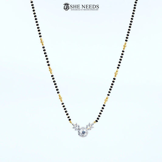 Full view of Anvika Gold Plated AD Leaf Mangalsutra with sparkling round American Diamond pendant, leaf design and black bead chain.|She Needs Jewellery
