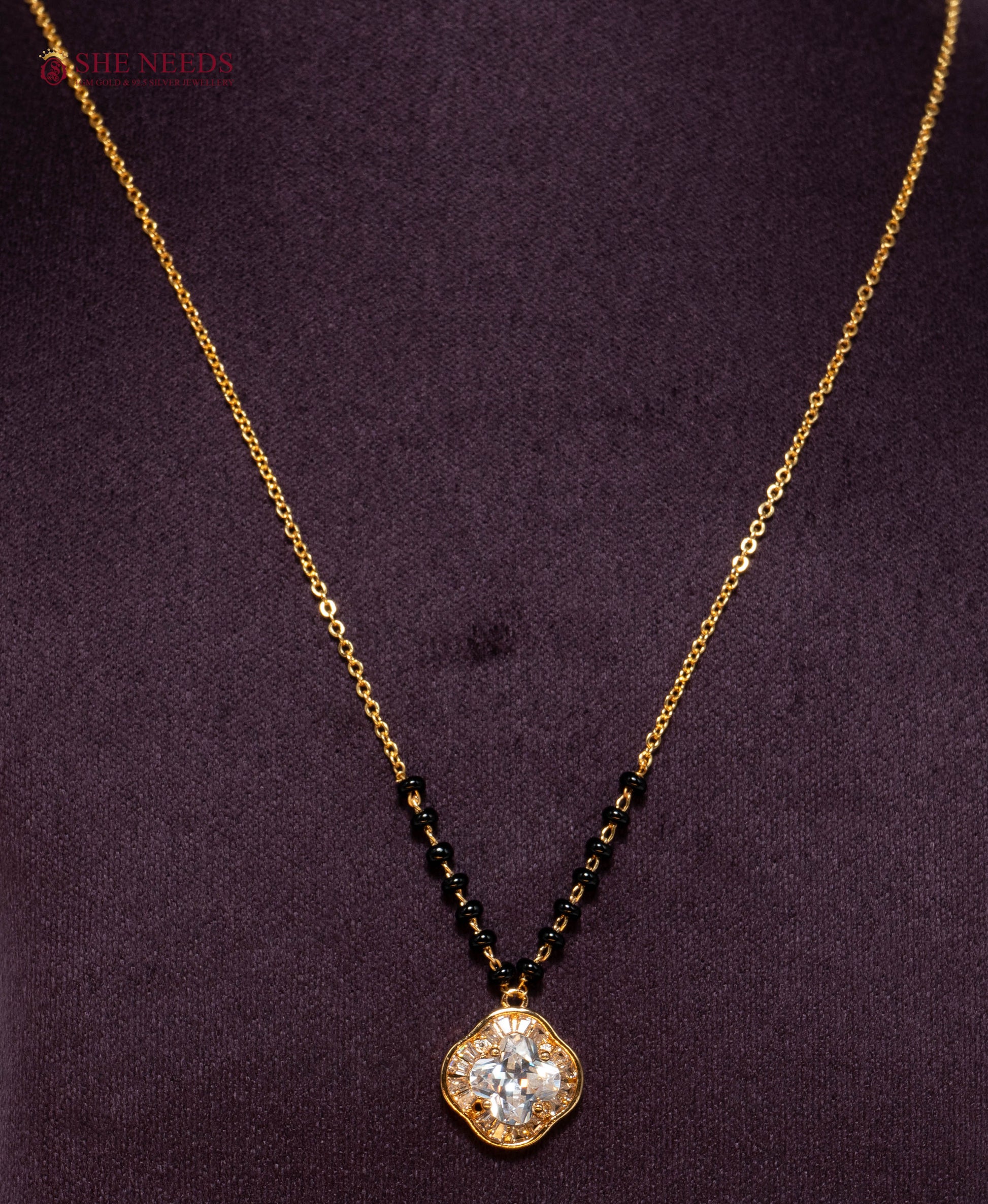 Shop the Clover American Diamond Mangalsutra Necklace featuring a sparkling clover-shaped CZ pendant, premium gold plating, and traditional black beads. Perfect for daily wear, office wear, festive occasions, and gifting.