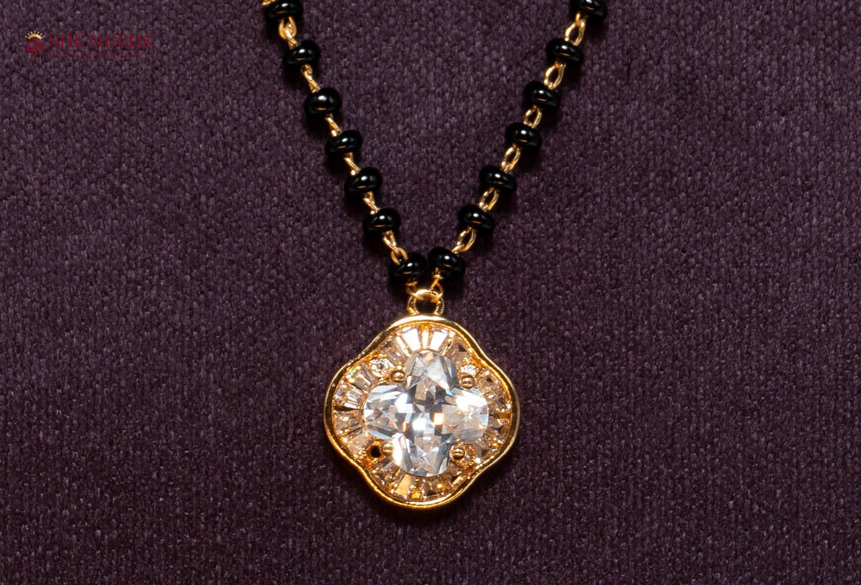 Shop the Clover American Diamond Mangalsutra Necklace featuring a sparkling clover-shaped CZ pendant, premium gold plating, and traditional black beads. Perfect for daily wear, office wear, festive occasions, and gifting.