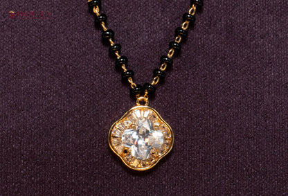 Shop the Clover American Diamond Mangalsutra Necklace featuring a sparkling clover-shaped CZ pendant, premium gold plating, and traditional black beads. Perfect for daily wear, office wear, festive occasions, and gifting.