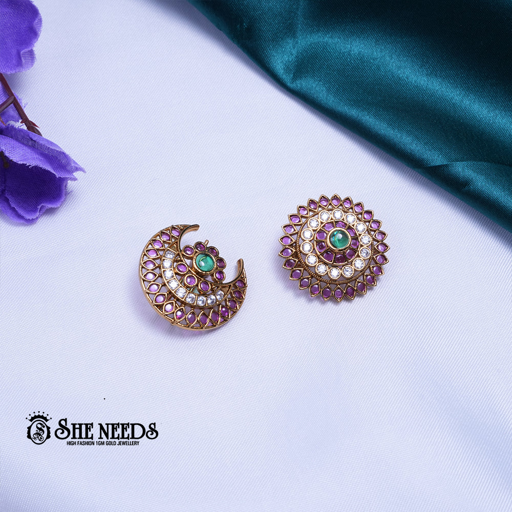 Antique gold Sun and Moon saree pin brooch set featuring sparkling kundan stones, ruby-pink accents, emerald-green center stones, and intricate celestial-inspired craftsmanship.|She Needs Jewellery
