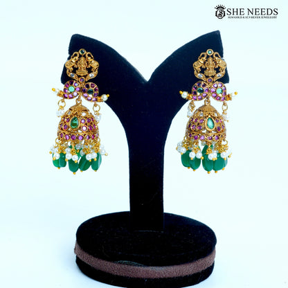 Devika pair of temple dome jhumka earrings with green and pink stones, pearl drops and gold-toned detailing|She Needs Jewellery
