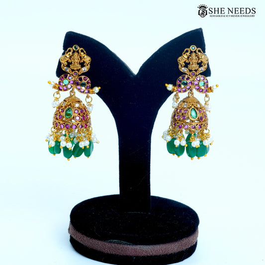 Devika pair of temple dome jhumka earrings with green and pink stones, pearl drops and gold-toned detailing|She Needs Jewellery
