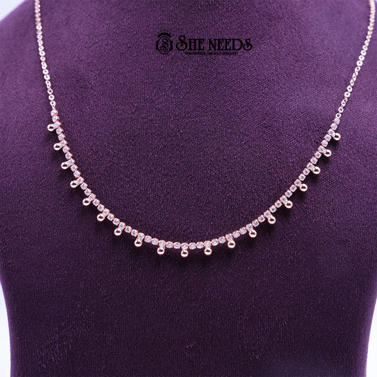 Rose gold Droplet Grace necklace featuring sparkling CZ stones and delicate droplet-shaped danglers arranged along a fine chain, displayed on a purple jewelry bust. |She Needs Jewellery