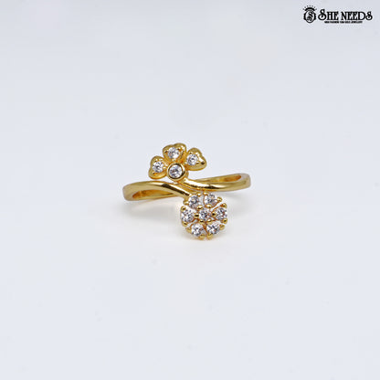 Gold-plated adjustable open ring featuring dual floral cubic zirconia clusters connected by an elegant crossover band on a white background.|She Needs Jewellery
background.
