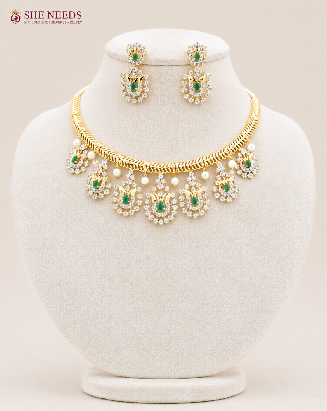 Elegant emerald green AD stone choker necklace set with matching designer earrings in premium gold finish displayed on white mannequin.