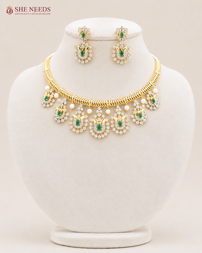 Elegant emerald green AD stone choker necklace set with matching designer earrings in premium gold finish displayed on white mannequin.