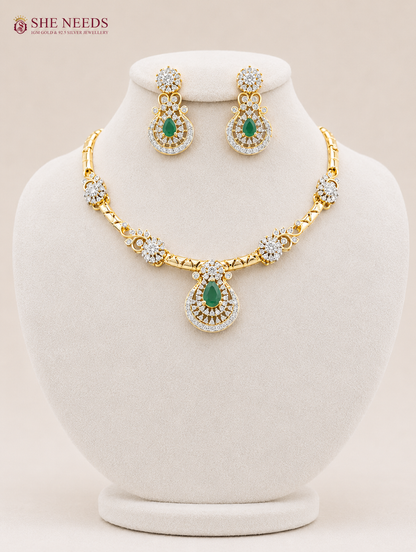 Elegant emerald green AD stone pendant necklace set with matching designer earrings in premium gold finish displayed on white mannequin