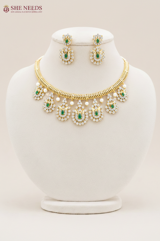 Emerald Green American Diamond Stone Choker Necklace Set with matching earrings featuring sparkling CZ stones, emerald green teardrop stones, and gold finish | She Needs Jewellery