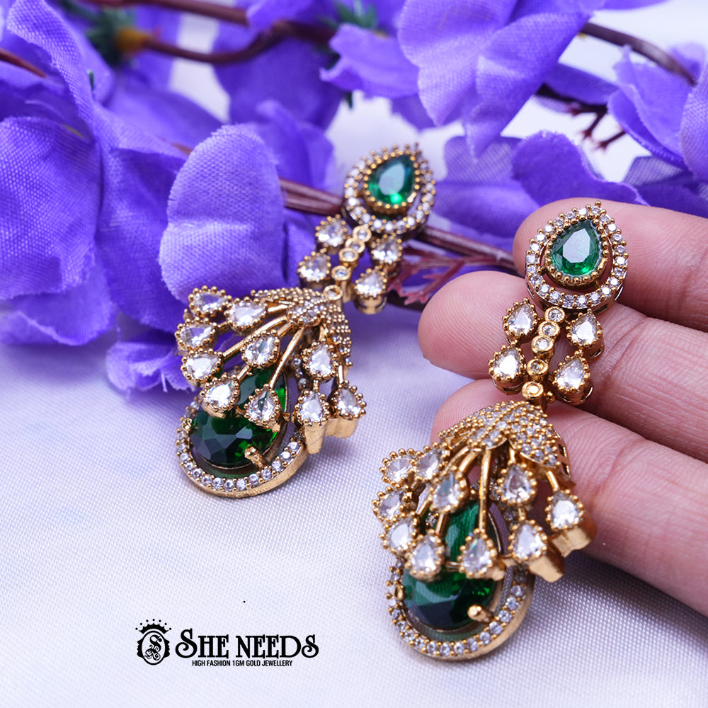 Elegant emerald green long drop earrings with American diamonds and gold polish from She Needs Jewellery