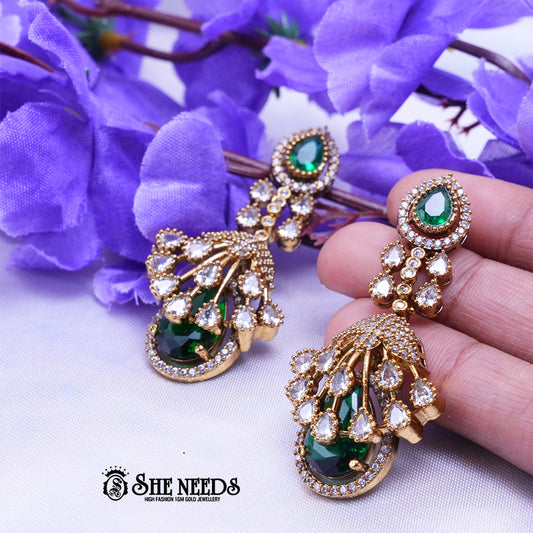 Elegant emerald green long drop earrings with American diamonds and gold polish from She Needs Jewellery