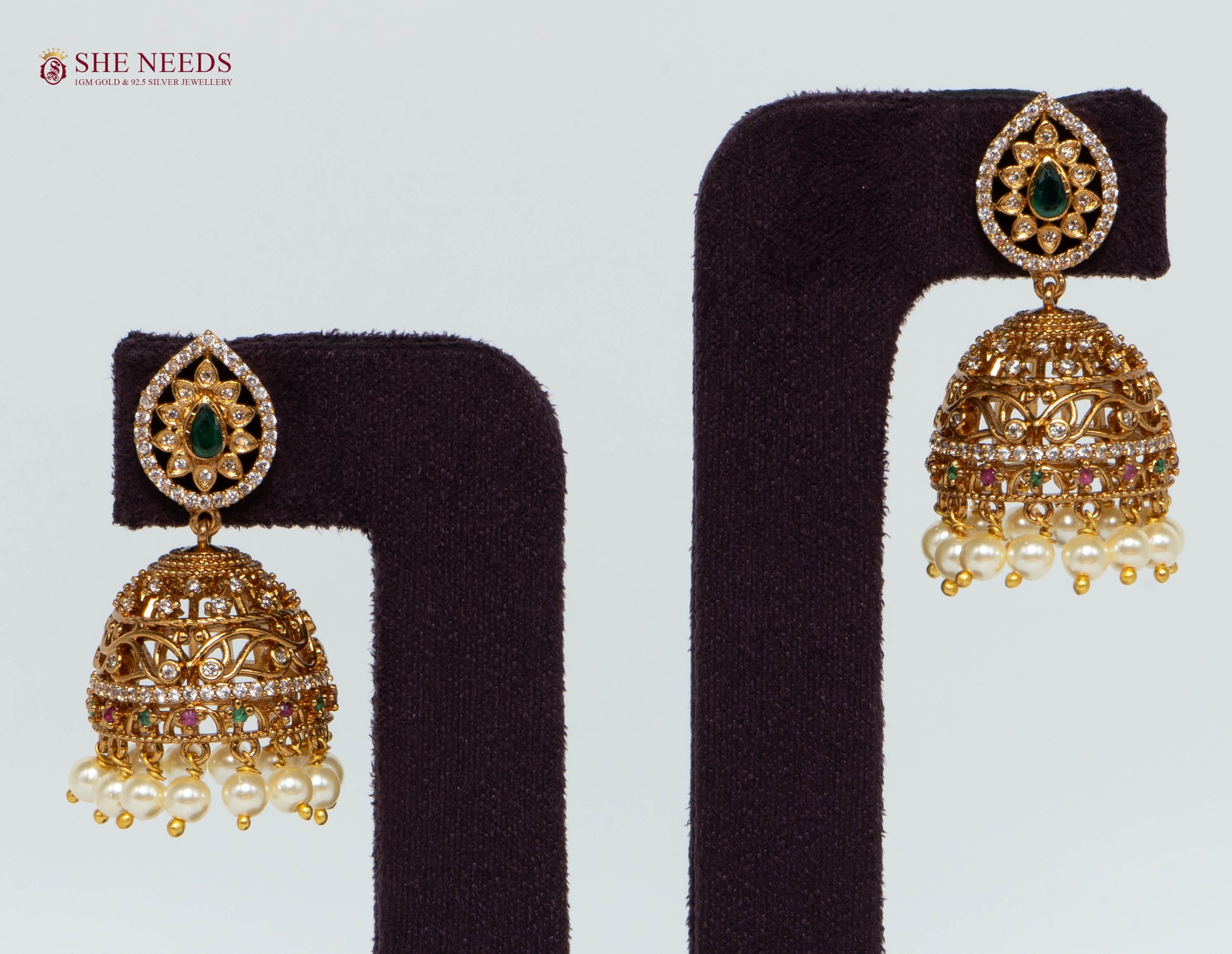 Gold Plated Emerald Pearl Dome Jhumka Earrings with American Diamonds, emerald-green stone, multicolor accents and pearl drops by She Needs Jewellery