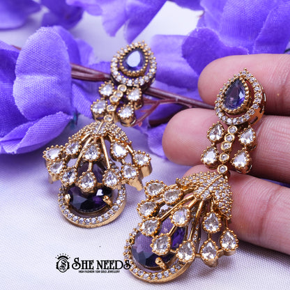 Elegant emerald  Purple long drop earrings with American diamonds and gold polish from She Needs Jewellery