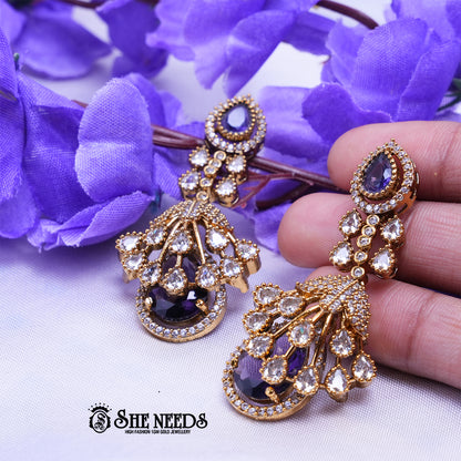 Elegant emerald Purple long drop earrings with American diamonds and gold polish from She Needs Jewellery