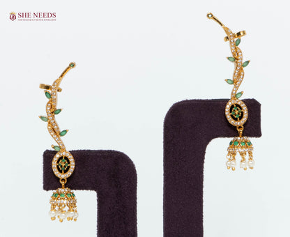 Gold-plated emerald vine ear cuff jhumka earrings with green stones, American Diamonds, and pearl drops for bridal and festive wear.|She Needs Jewellery
