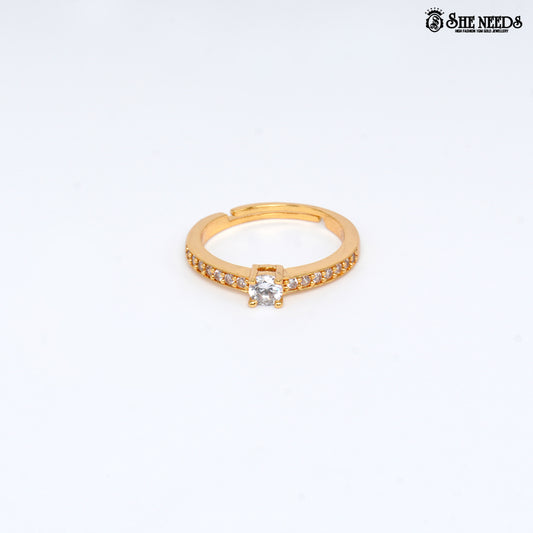 Gold-plated adjustable solitaire ring featuring a round-cut cubic zirconia center stone and pavé-set CZ stones on the band against a white background |She Needs Jewellery