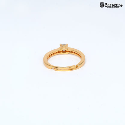 Gold-plated adjustable solitaire ring featuring a round-cut cubic zirconia center stone and pavé-set CZ stones on the band against a white background |She Needs Jewellery